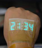 A stretchable stopwatch lights up human skin