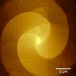 Do the twist: Making two-dimensional quantum materials using curved surfaces