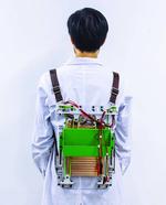 Load-reducing backpack powers electronics by harvesting energy from walking