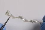 Dissolving implantable device relieves pain without drugs
